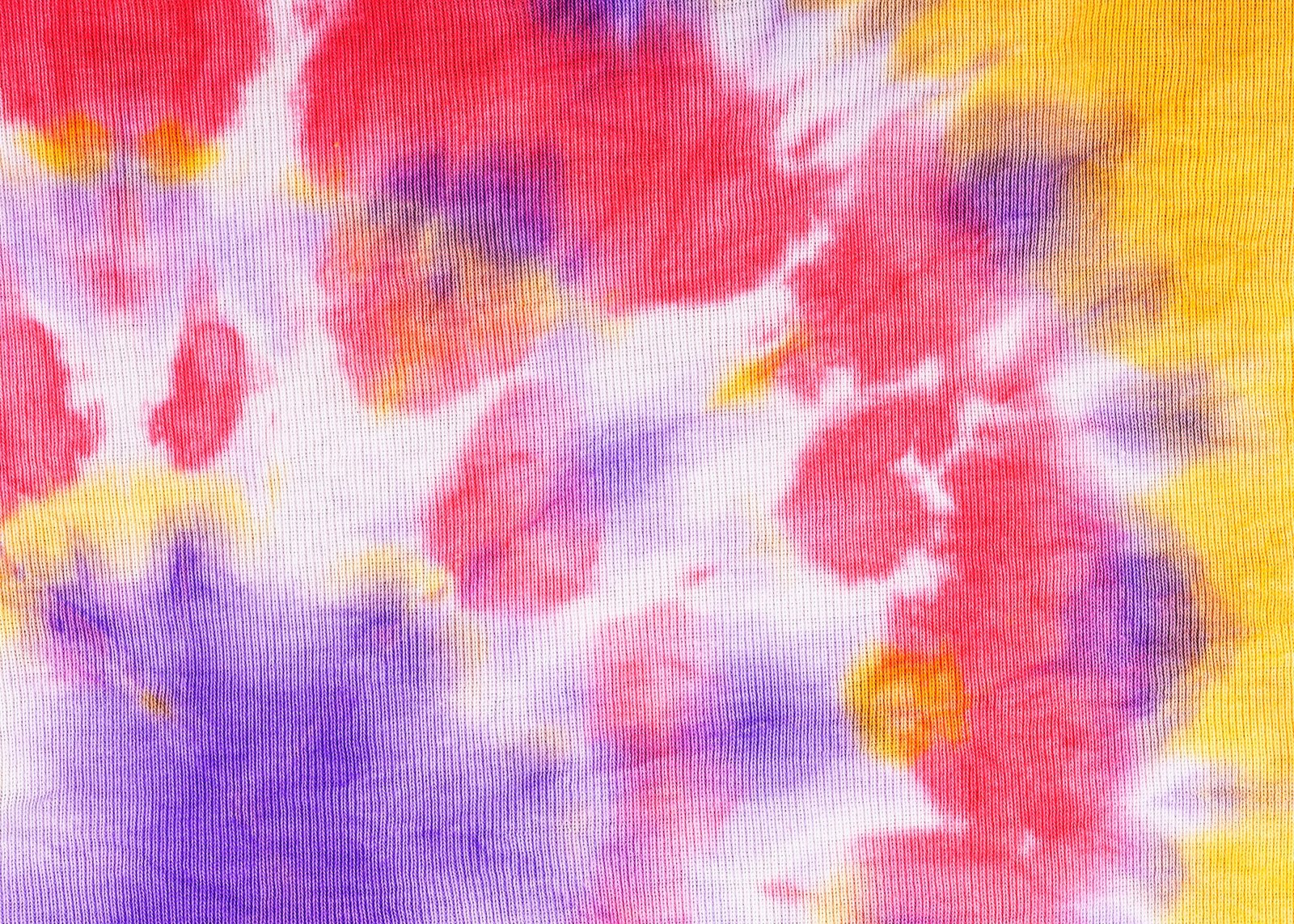 Close-up pink, purple, and yellow tie-dyed fabric